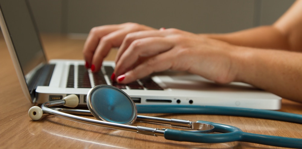 healthcare revenue cycle management - medical employee on a computer